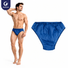 Justcare disposable men's briefs single item, deep blue non-woven triangle underwear flat lay on white background, breathable elastic waistband