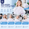 Justcare disposable non-woven hair cutting cape closeup. White salon cape with round neck, water droplets to show waterproof function. Stacked capes on the left, salon background. Features: lightweight breathable, single-use hygienic, waterproof, multi-purpose for salon barber spa.