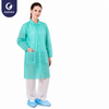 Justcare snap‑fastened lab coat, mint green disposable non‑woven lab coat with pockets, model shot on plain white background