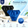 Justcare disposable men's briefs color variants, black and deep blue non-woven underwear on stone background, premium quality product photo