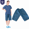 Justcare unisex disposable sauna boxers, model wearing polyester non‑woven spa shorts with flat lay product view