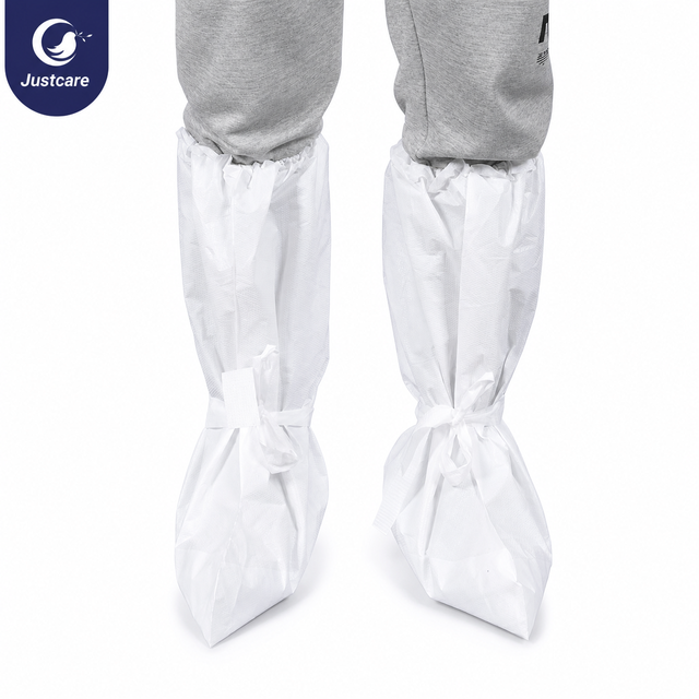 Person wearing Justcare disposable high-top boot covers over pants, secured with back ties and elastic top for secure fit